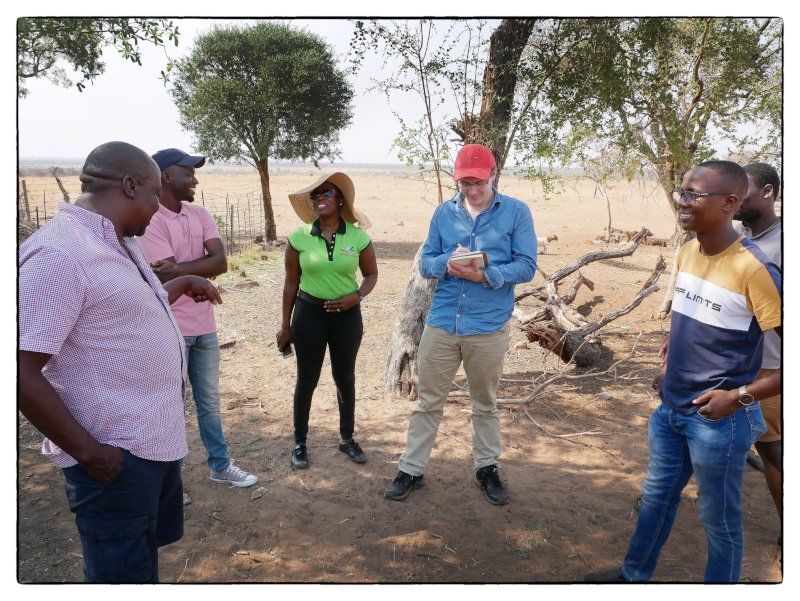 Mr Lucas Msiza talking about his breeding operations on the farm to a mixed group of researchers